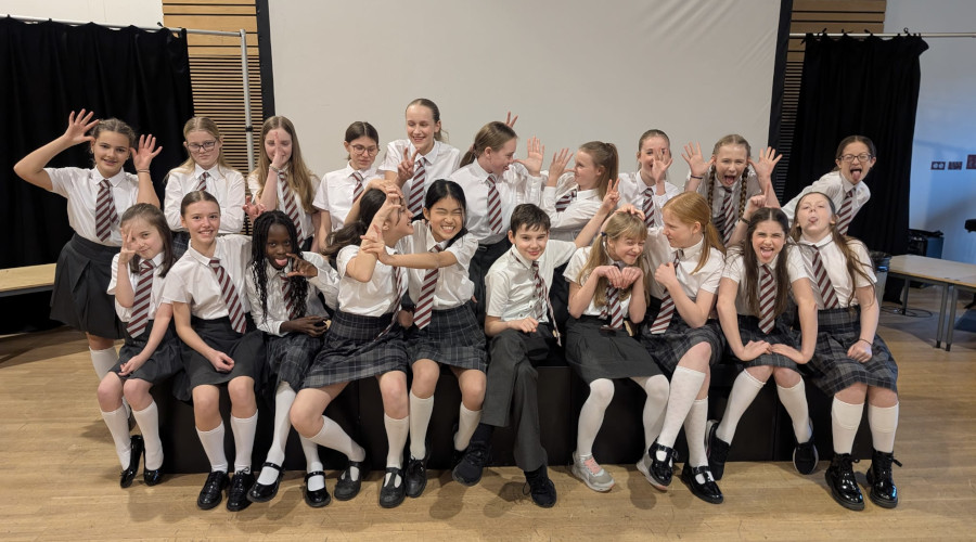 naughty cast of matilda dressed in school uniform pulling funny faces