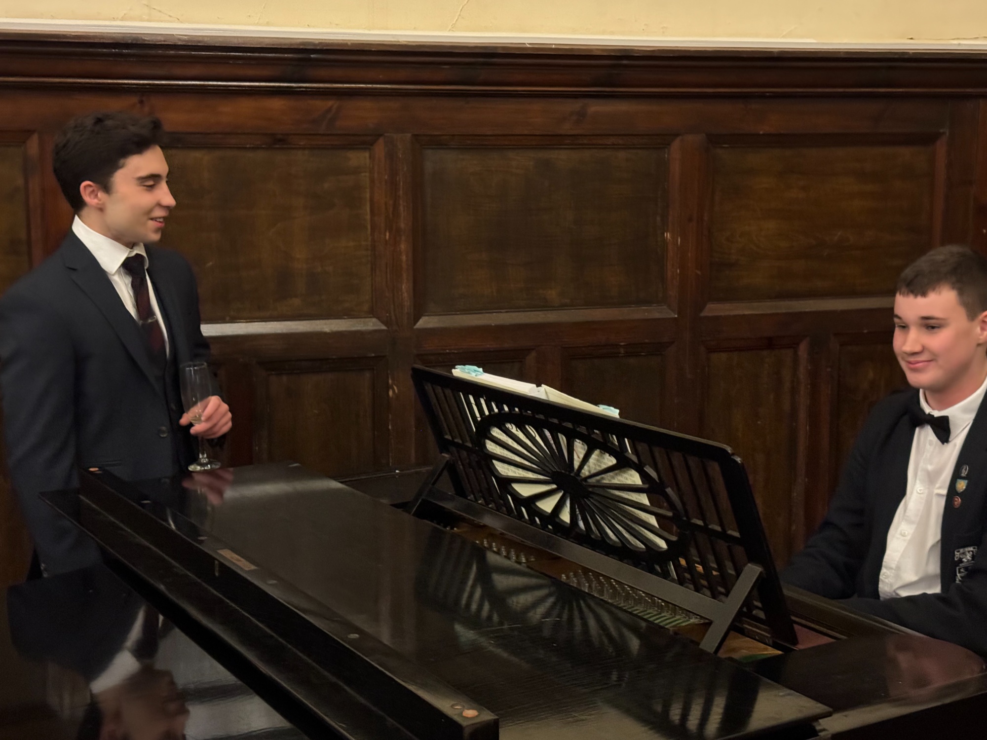 Attendees enjoy musical accompaniment from Freddie on the baby grand piano