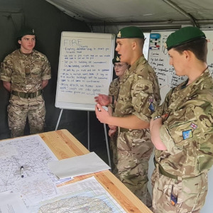 Cadets working on a project infront of white boards