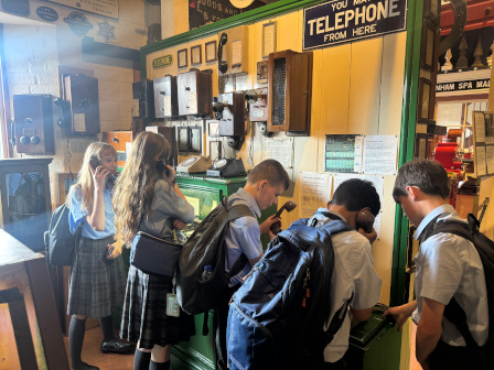 Students huddle around historic rail artifacts in the museum