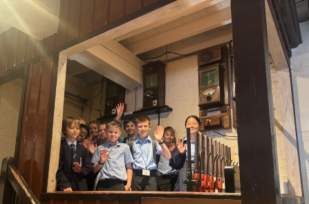 Students pose in a signal box