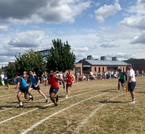 Senior boys tackle a fast relay change-over