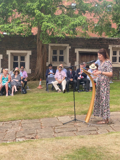 Cat Eccles MP for Stourbridge standing at a lectern delivering a speech to an audience of OSH students, families and friends