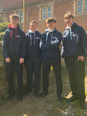 4 boys casually stand with new Year 11 "end of an era" hoodies