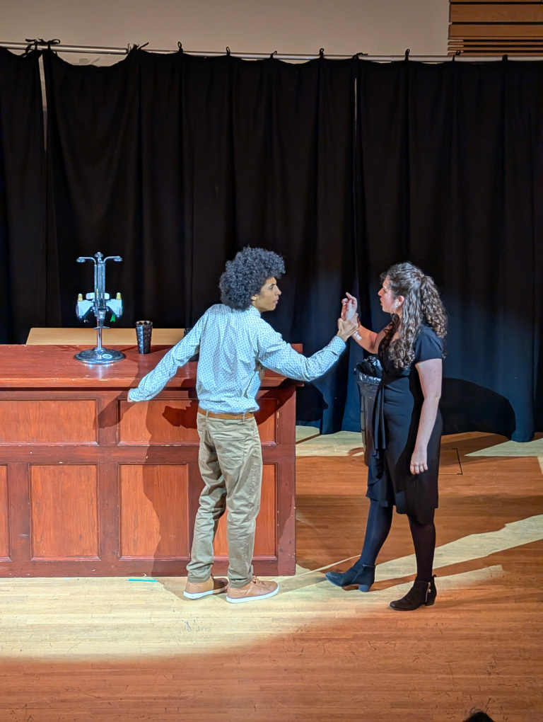 Two actors on stage in a visible argument